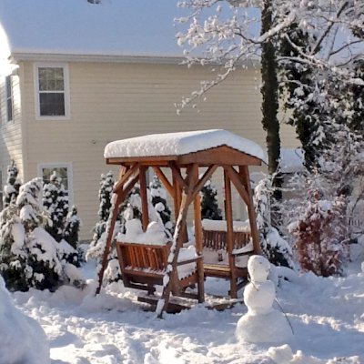 St. Anthony's Face to Face Gliders (Adult Size, California Redwood, No Kid's Platform, Standard Closed Roof, No Engraving, Transparent Premium Sealant). Photo Courtesy Kathy and Jutta of Montclair, NJ.