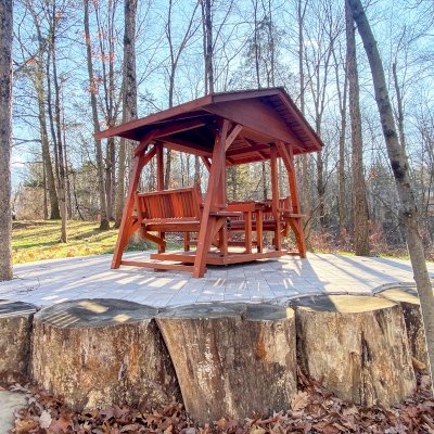 St. Anthony's Face to Face Gliders (Options: Extra Wide Size, Mature Redwood, With Beverage Armrests, with Custom Table, No Kid's Platform, XW Roof, No Engraving, Transparent Premium Sealant). Photo Courtesy of The Jones Family of Cortlandt Manor, New York