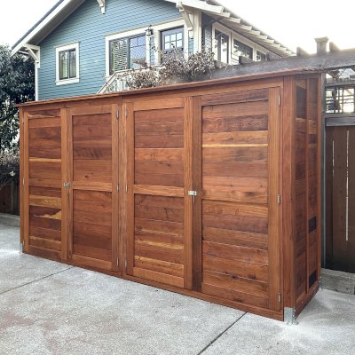 Storage Shed (Options: 12' W, 3' D, 7' H, California Redwood, Double Doors Opening Out From Center, No Shelving, with Interior Flooring, Hardware Kit for Concrete, Transparent Premium Sealant). Photo Courtesy of K. Bennett of Portland, OR.