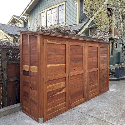 Storage Shed (Options: 12' W, 3' D, 7' H, California Redwood, Double Doors Opening Out From Center, No Shelving, with Interior Flooring, Hardware Kit for Concrete, Transparent Premium Sealant). Photo Courtesy of K. Bennett of Portland, OR.