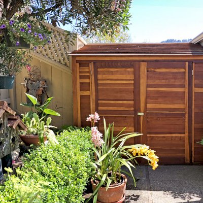 Storage Sheds (Options: 7' W, 4.5' D, 7' H, California Redwood, Double Doors, No Shelving, With Deck, Transparent Premium Sealant). Photo Courtesy of I. Speiser of Carmel, CA