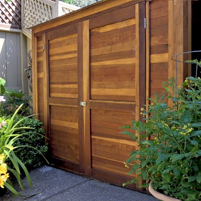 Storage Sheds (Options: 7' W, 4.5' D, 7' H, California Redwood, Double Doors, No Shelving, With Deck, Transparent Premium Sealant). Photo Courtesy of I. Speiser of Carmel, CA