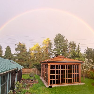 Still Warm and Inviting Even in the Rain. Sun Gazebo with Sliding Doors (Options: 20' L x 16' W, Exterior Skin and Roofing in California Redwood, Rest of Structure Will Be in Douglas-Fir, 9 ft Wall Height, With 4' x 8' Skylight, No Flooring, Standard Wood Roof, Roof with Two Additional Beams to Handle Swing Stresses, Transparent Premium Sealant). Photo Courtesy of R. Huffman of Seattle, WA.