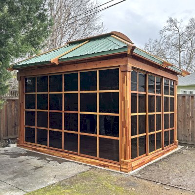 Sun Gazebo with Sliding Doors (Options: 14' L x 12' W, Mosaic Redwood, 8 ft Wall Height, 4' x 6' Skylight, with 3 Sliding Walls and One Fixed Wood Wall, Complete Floor, with Metal Roof, Transparent Premium Sealant). Photo Courtesy of A. Winings of San Jose, CA.