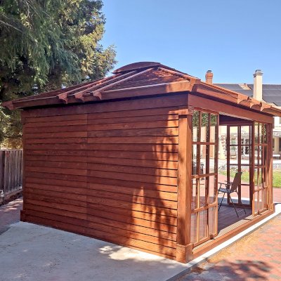 Custom Sun Gazebo with Sliding Doors (Options: 16' L x 14' W, Douglas-fir, 3 Sides with Sliding Doors and 1 Side with Solid Wall, 8 ft Wall Height, 4' x 6' Skylight, with Floor, Transparent Premium Sealant). Clear Polycarbonate Windows by Custom Request. Photo Courtesy of B. Narayanan of Pleasanton, CA.