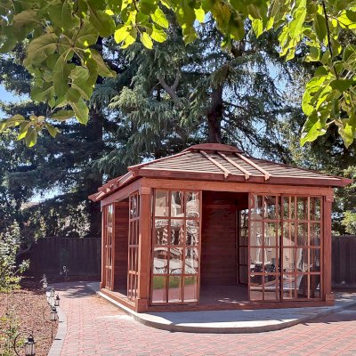 Custom Sun Gazebo with Sliding Doors (Options: 16' L x 14' W, Douglas-fir, 3 Sides with Sliding Doors and 1 Side with Solid Wall, 8 ft Wall Height, 4' x 6' Skylight, with Floor, Transparent Premium Sealant). Clear Polycarbonate Windows by Custom Request. Photo Courtesy of B. Narayanan of Pleasanton, CA.