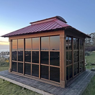 Sun Gazebo with Sliding Doors (Options: 12' L x 10' W, California Redwood, 7 ft Wall Height, 4' x 6' Skylight, with 4 Sliding Walls, No Floor, with Metal Roof, Transparent Premium Sealant). Photo Taken 2 Years After Installation. Photo Courtesy of C. Turner of Bodega Bay, CA.