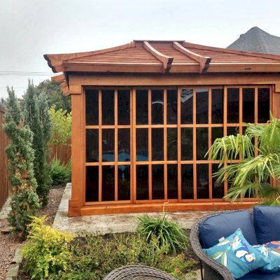 Sun Gazebo with Sliding Doors (Options: 12' L, 10' W, Mature Redwood, 7 ft Wall Height, Without Skylight, Standard Wood Roof, Hardware Kit for Stone, Brick or Concrete, Complete Floor, Transparent Premium Sealant). Photo Courtesy of J. Davidson of Plano, Texas.