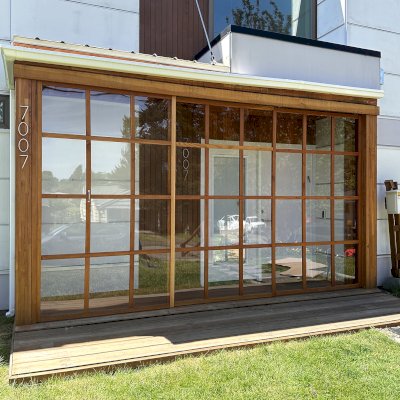 Custom Sun Gazebo (Options: 14'-6" x 3', with Floor and 14' x 3'-5" Front Deck, Mosaic Douglas-Fir, 3 Sides Only, Front Side with Sliding Doors and 2 Fixed Panels on 2 Sides, Transparent Premium Sealant). Photo Taken 1 Year After Installation. Photo Courtesy of M. Frasch of Seattle, WA.