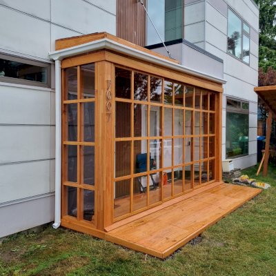 Custom Sun Gazebo (Options: 14'-6" x 3', with Floor and 14' x 3'-5" Front Deck, Mosaic Douglas-Fir, 3 Sides Only, Front Side with Sliding Doors and 2 Fixed Panels on 2 Sides, Transparent Premium Sealant). Photo Courtesy of M. Frasch of Seattle, WA.