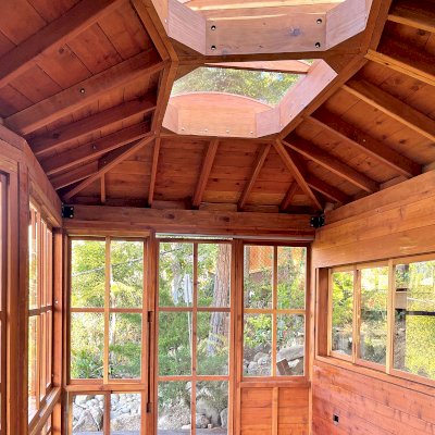 Custom Sun Gazebo with Sliding Doors (Options: Irregular Shape, 20' L x 12' W, California Redwood, 7 ft Wall Height, With Custom Skylight, Without Floor [Installed on a Deck], Transparent Premium Sealant). Clear Polycarbonate Windows by Custom Request. Photo Courtesy of P. Gupta of Los Gatos, CA.