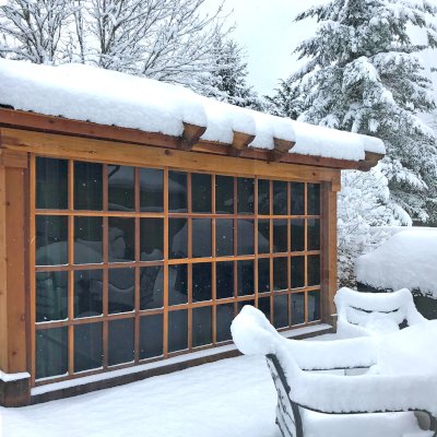 Sun Gazebo with Sliding Doors (Options: 14' L, 12' W, California Redwood, 4' x 4' Skylight, Complete Floor, Transparent Premium Sealant). Metal roof added by custom request. Photo Courtesy of P. Gee of Sammamish, Washington. 