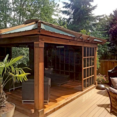 Sun Gazebo with Sliding Doors (Options: 14' L, 12' W, California Redwood, 4' x 4' Skylight, Complete Floor, Transparent Premium Sealant). Metal roof added by custom request. Photo Courtesy of P. Gee of Sammamish, Washington. 