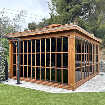 Sun Gazebo with Sliding Doors (Options: 20' L x 16' W, California Redwood, 8.5 ft Wall Height, 4' x 6' Skylight, Complete Floor, Shiplap Roof, TV Mount and Electrical Cutouts by Custom Request, Acrylic Color Bronze, Transparent Premium Sealant). Photo Courtesy of S. & L. McEwan of San Juan Capistrano, CA.