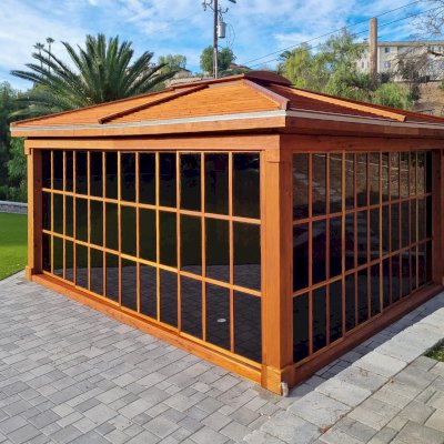 Sun Gazebo with Sliding Doors (Options: 20' L x 16' W, California Redwood, 9 ft Wall Height, 4' x 6' Skylight, with 3 Sliding Walls and One Fixed Wood Wall, Complete Floor, Shiplap Roof, Transparent Premium Sealant). Photo Courtesy of S. McEwan of San Juan Capistrano, CA.