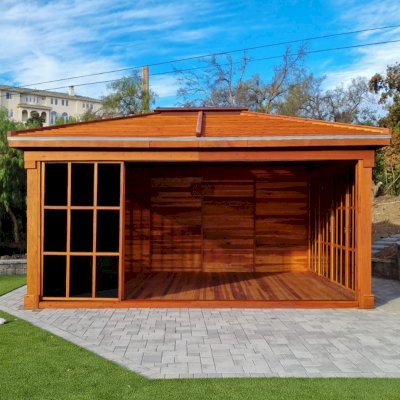 Sun Gazebo with Sliding Doors (Options: 20' L x 16' W, California Redwood, 9 ft Wall Height, 4' x 6' Skylight, with 3 Sliding Walls and One Fixed Wood Wall, Complete Floor, Shiplap Roof, Transparent Premium Sealant). Photo Courtesy of S. McEwan of San Juan Capistrano, CA.