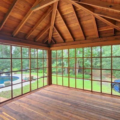 Sun Gazebo with Sliding Doors (Options: 20' L x 14' W, Mature Redwood, 8 ft Wall Height, Without Skylight, with 3 Sliding Walls and One Fixed Wood Wall, Custom Complete Floor and Bridge, Transparent Premium Sealant). Photo Courtesy of T. Bolek of Tallahassee, Florida.