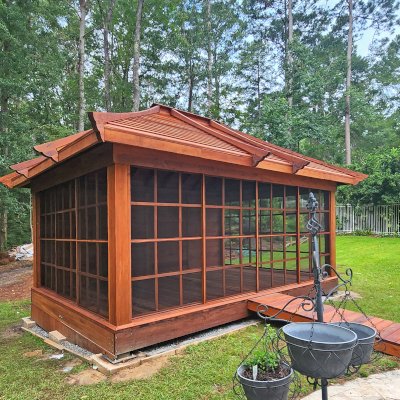 Sun Gazebo with Sliding Doors (Options: 20' L x 14' W, Mature Redwood, 8 ft Wall Height, Without Skylight, with 3 Sliding Walls and One Fixed Wood Wall, Custom Complete Floor and Bridge, Transparent Premium Sealant). Photo Courtesy of T. Bolek of Tallahassee, Florida.
