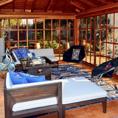 Sun Gazebo with Sliding Doors (Options: 14' L, 12' W, California Redwood, 4' x 6' Skylight, Complete Floor, Transparent Premium Sealant). Metal roof added by custom request. Photo Courtesy of A. Ramon of South San Francisco, CA.