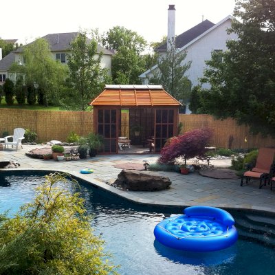 Sun Gazebo with Sliding Doors (Options: 12' L, 10' W, Mature Redwood, 4' x 8' Skylight, No Flooring, Transparent Premium Sealant). Cement Anchors on 4 x 4 posts by Custom Request. Photo Courtesy of Clay Rutledge of Audubon, Pennsylvania.