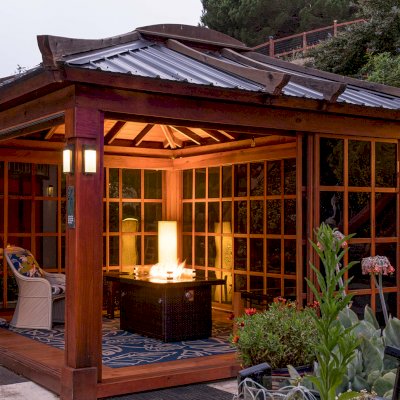 Sun Gazebo with Sliding Doors (Options: 14' L, 12' W, California Redwood, 4' x 6' Skylight, Complete Floor, Transparent Premium Sealant). Metal roof added by custom request. Photo Taken 4 Years After Installation. Photo Courtesy of A. Ramon of South San Francisco, CA. Note: Metal Roof provided by Home Depot: 12ft. Classic Rib Steel Roof Panel in Charcoal, Model #2313417, Internet #204255071