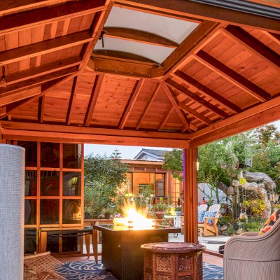 Sun Gazebo with Sliding Doors (Options: 14' L, 12' W, California Redwood, 4' x 6' Skylight, Complete Floor, Transparent Premium Sealant). Metal roof added by custom request. Photo Taken 4 Years After Installation. Photo Courtesy of A. Ramon of South San Francisco, CA. Note: Metal Roof provided by Home Depot: 12ft. Classic Rib Steel Roof Panel in Charcoal, Model #2313417, Internet #204255071