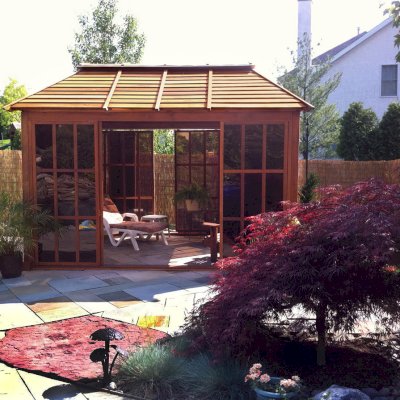 Sun Gazebo with Sliding Doors (Options: 12' L, 10' W, Mature Redwood, 4' x 8' Skylight, No Flooring, Transparent Premium Sealant). Cement Anchors on 4 x 4 posts by Custom Request. Photo Courtesy of Clay Rutledge of Audubon, Pennsylvania.