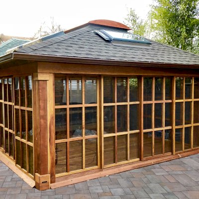 Sun Gazebo with Sliding Doors (Options: 16' L, 16' W, California Redwood, 4' x 8' Skylight, Complete Floor, Transparent Premium Sealant). Skylights and asphalt shingles by custom request. Photo Courtesy of S. Alishaev of New York, NY.