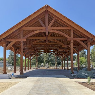 Cardinal's Nest Pavilion (Options: 60' x 40', California Redwood, Horizontal Decorative Trims for All Posts, 15' H Posts, 10x10 Posts, 2 Ceiling Fan Bases, Transparent Premium Sealant). Pavilion Installed in Faith Walk Community Fitness Park in Coeur d'Alene, Idaho.