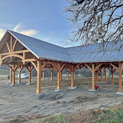 Custom Cardinal's Nest Pavilion (Options: 74' x 74', Douglas-fir, 20-Post Anchor Kit for High-Wind, 10' H Posts, Horizontal Decorative Trims for All Posts, with 5 Ceiling Fan Bases, Transparent Premium Sealant, White Wash for Ceiling). Photo Courtesy of J. Fookes of Elk Creek, CA.