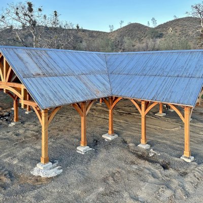 Custom Cardinal's Nest Pavilion (Options: 74' x 74', Douglas-fir, 20-Post Anchor Kit for High-Wind, 10' H Posts, Horizontal Decorative Trims for All Posts, with 5 Ceiling Fan Bases, Transparent Premium Sealant, White Wash for Ceiling). Photo Courtesy of J. Fookes of Elk Creek, CA.