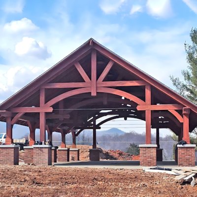 Cardinal's Nest Pavilion (Options: 55' L x 34' W, Mosaic Douglas-Fir, Parquet Roof, with 4 Ceiling Fan Bases, 10x10 Posts, 7' H Posts, Coffee-Stain Premium Sealant). On-going assembly work still not completed. Project is located on the campus of Milligan University, 1 Blowers Blvd. Milligan, TN.