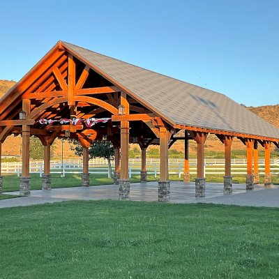 Cardinal's Nest Pavilion (Options: 60' L x 34' W, Douglas-fir, 5 Ceiling Fan Bases, 9' H Posts, Horizontal Post Decorative Trims, Post Anchor Kit for High-Wind, Transparent Premium Sealant). Photo Courtesy of S. Wagner of Naches, WA.