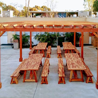 Classic Redwood Patio Table (Options: 10' L x 36" W, Mosaic Redwood, Side Benches, 2 Half Length Benches Per Side, Old Country Tabletop, Standard, Slightly Rounded Corners, No Umbrella Hole, Transparent Premium Sealant). Photo Also Shows a Garden Pergola. Photo Courtesy of T. Sirvent. Tables Installed in Vanguard University, Costa Mesa, CA.