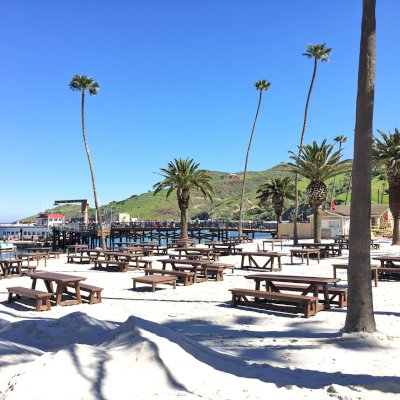 Classic Redwood Patio Table (Options: California Redwood, Side Benches, 1 Full Length Bench Per Side, Standard Tabletop, Slightly Rounded Corners, No Umbrella Hole, Coffee Stain Premium Sealant). Photo Shows Customized Version of Patio Tables. Tables Installed in Catalina Island, CA.