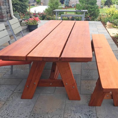 Classic Redwood Patio Table (Options: 8' L, 34 ½" W, Side Bench, Mature Redwood, 1 Full Length Side Bench on One Side, Custom Tabletop [3-Plank Bookmatch Top], Slightly Rounded Corners, No Umbrella Hole, Transparent Premium Sealant). Photo Courtesy of J. Gannon of Broomfield, CO.