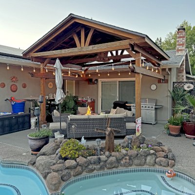 Custom Del Norte Porch Pavilion (Options: 14' L x 16' W, California Redwood, 2-Post Anchor Kit for Concrete, 10.5' H Posts, 1 Ceiling Fan Base, No Electrical Wiring Trim Kit, No Post Decorative Trims, Transparent Premium Sealant). Photo Taken 2 Years After Installation. Photo Courtesy of R. Dakin of Vacaville, CA.