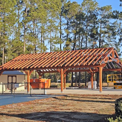 Esther Scissor Truss Pavilion (Options: 45’ L x 35’ W, California Redwood, Standard 3/4" T&G Roof Boards, 10' H Posts, with 3 Ceiling Fan Bases, 8 High-Wind Post Anchors, Transparent Premium Sealant). Photo Courtesy of F. Parini of Myrtle Beach, South Carolina.