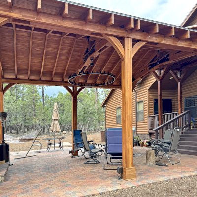 Esther Scissor Truss Pavilion (Options: 22’ L x 18’ W, Mosaic Douglas-Fir, Standard 3/4" T&G Roof Boards, 9.5' H Posts, No Ceiling Fan Base, 6 High-Wind Post Anchors, Cutout to fit Chimney on the Back, Transparent Premium Sealant). Photo Courtesy of H. O'Riley of Lakeside, AZ.