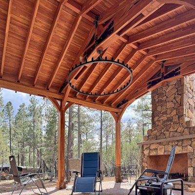 Esther Scissor Truss Pavilion (Options: 22’ L x 18’ W, Mosaic Douglas-Fir, Standard 3/4" T&G Roof Boards, 9.5' H Posts, No Ceiling Fan Base, 6 High-Wind Post Anchors, Cutout to fit Chimney on the Back, Transparent Premium Sealant). Photo Courtesy of H. O'Riley of Lakeside, AZ.