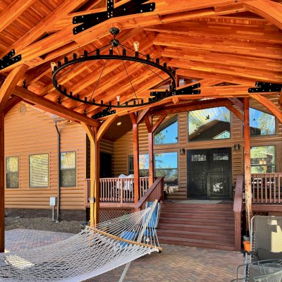 Esther Scissor Truss Pavilion (Options: 22’ L x 18’ W, Mosaic Douglas-Fir, Standard 3/4" T&G Roof Boards, 9.5' H Posts, No Ceiling Fan Base, 6 High-Wind Post Anchors, Cutout to fit Chimney on the Back, Transparent Premium Sealant). Photo Courtesy of H. O'Riley of Lakeside, AZ.