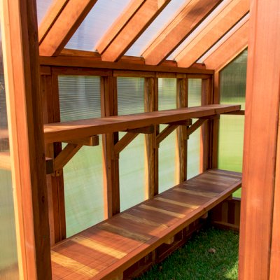 The Forever Hot House (Options: 8 ft L x 6 ft W, California Redwood, 2 shelves long, Transparent Premium Sealant). This Forever Hot House was assembled on a lawn for a photo shoot. We recommend installation be on a developed hardscape of your choosing and not bare soil or lawn.