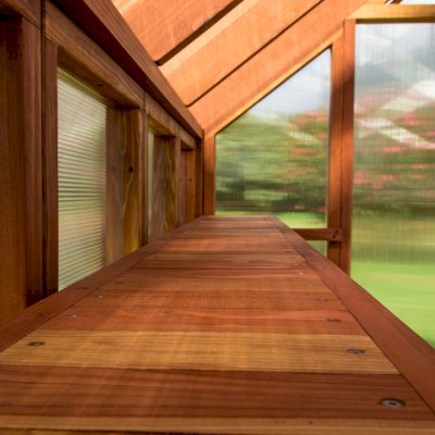 The Forever Hot House (Options: 8 ft L x 6 ft W, California Redwood, 2 shelves long, Transparent Premium Sealant). The photo shows the detail of the shelves.