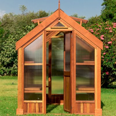 The Forever Hot House (Options: 8 ft L x 6 ft W, California Redwood, 2 shelves long, Transparent Premium Sealant). This Forever Hot House was assembled on a lawn for a photo shoot. We recommend installation be on a developed hardscape of your choosing and not bare soil or lawn.