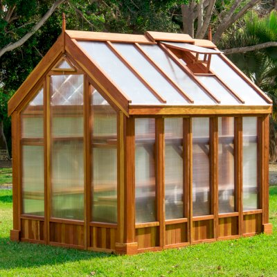 The Forever Hot House (Options: 8 ft L x 6 ft W, California Redwood, 2 shelves long, Transparent Premium Sealant). This Forever Hot House was assembled on a lawn for a photo shoot. We recommend installation be on a developed hardscape of your choosing and not bare soil or lawn.