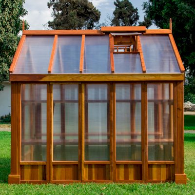 The Forever Hot House (Options: 8 ft L x 6 ft W, California Redwood, 2 shelves long, Transparent Premium Sealant). This Forever Hot House was assembled on a lawn for a photo shoot. We recommend installation be on a developed hardscape of your choosing and not bare soil or lawn.