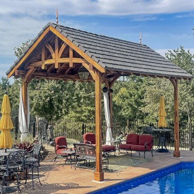 Custom Granada Pavilion (Options: 20 ft x 15 ft, Mosaic Redwood, 4-Post Anchor Kit for High-Wind, No Fascia Board, No Curtain Rods, 3 Ceiling Fan Bases, Transparent Premium Sealant). Shake from DaVinci Roof [https://www.davinciroofscapes.com/]. Photo Courtesy of K. Lowe of Newcastle, Oklahoma.
