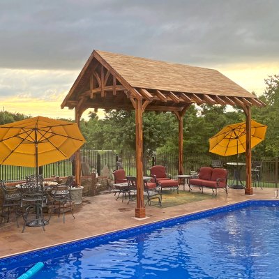 Custom Granada Pavilion Under Construction (Options: 20 ft x 15 ft, Mosaic Redwood, 4-Post Anchor Kit for High-Wind, No Fascia Board, No Curtain Rods, 3 Ceiling Fan Bases, Transparent Premium Sealant). Shake from DaVinci Roof [https://www.davinciroofscapes.com/]. Photo Courtesy of K. Lowe of Newcastle, Oklahoma.