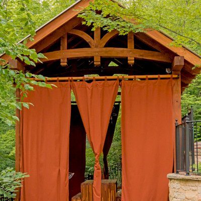 Granada Pavilion (Options: 6in x 6in post thickness, 18' L x 15' W, No Privacy Panels, California Redwood, No Fascia Board for Gutters, 10.5ft Post Height, 1 Electrical Wiring Trim, No Post Decorative Trim, 4-Post Anchor Kit for High-Wind, 3 Ceiling Fan Bases (CUSTOM REQUEST), 4 Heavy Duty Curtain Rods & Stainless Steel Hangars, Transparent Premium Sealant). Photo Courtesy of J. Rynerson of Franklin, Tennessee.