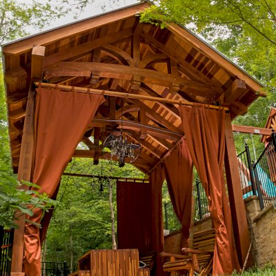 Granada Pavilion (Options: 6in x 6in post thickness, 18' L x 15' W, No Privacy Panels, California Redwood, No Fascia Board for Gutters, 10.5ft Post Height, 1 Electrical Wiring Trim, No Post Decorative Trim, 4-Post Anchor Kit for High-Wind, 3 Ceiling Fan Bases (CUSTOM REQUEST), 4 Heavy Duty Curtain Rods & Stainless Steel Hangars, Transparent Premium Sealant). Photo Courtesy of J. Rynerson of Franklin, Tennessee.